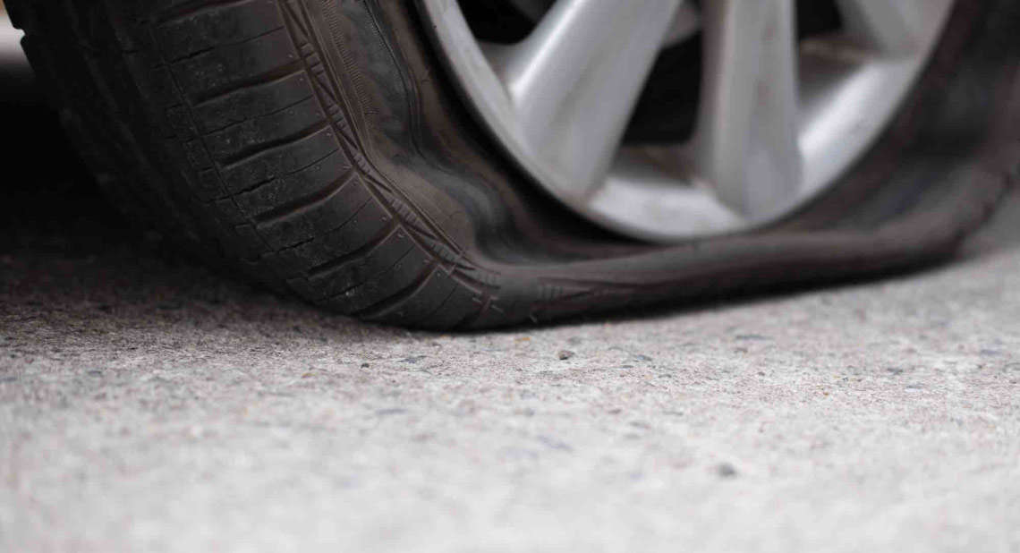 What should you do if you get a puncture while driving?