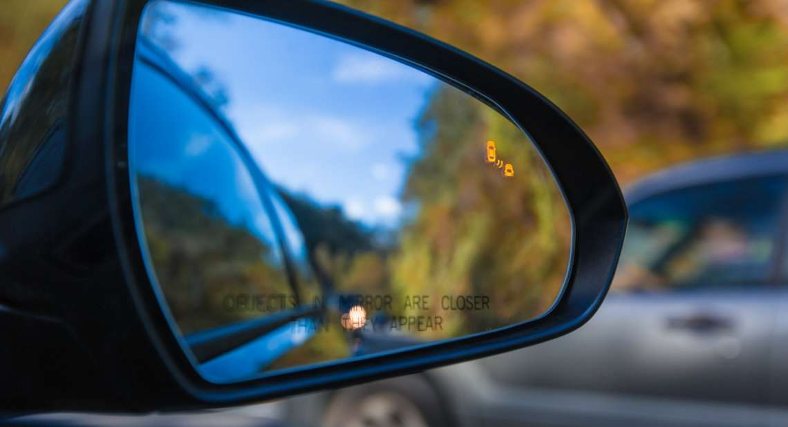 Objects in mirror are closer than they appear on car with Blind Spot Assist Warning LED Sensor Light