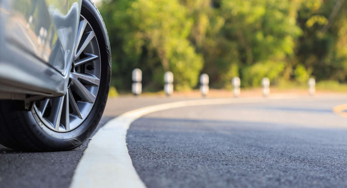 Front car wheel on the asphalt road
