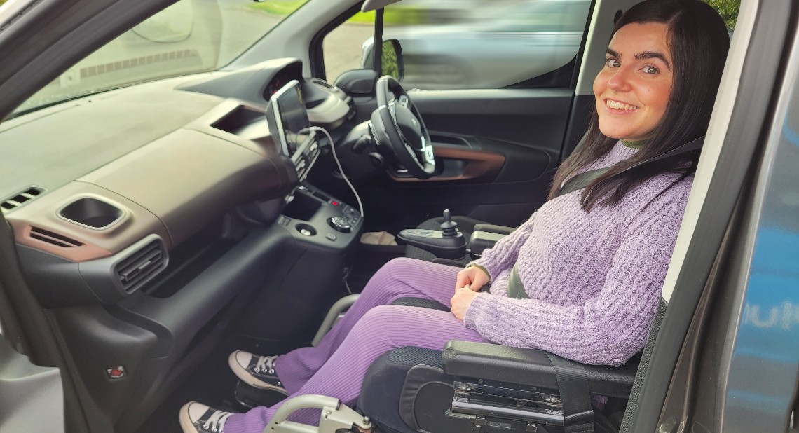 Emma Muldoon sitting in her up-front Wheelchair Accessible Vehicle (WAV)