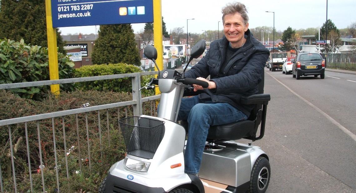 Disability writer Ian Cook driving his mobility scooter.