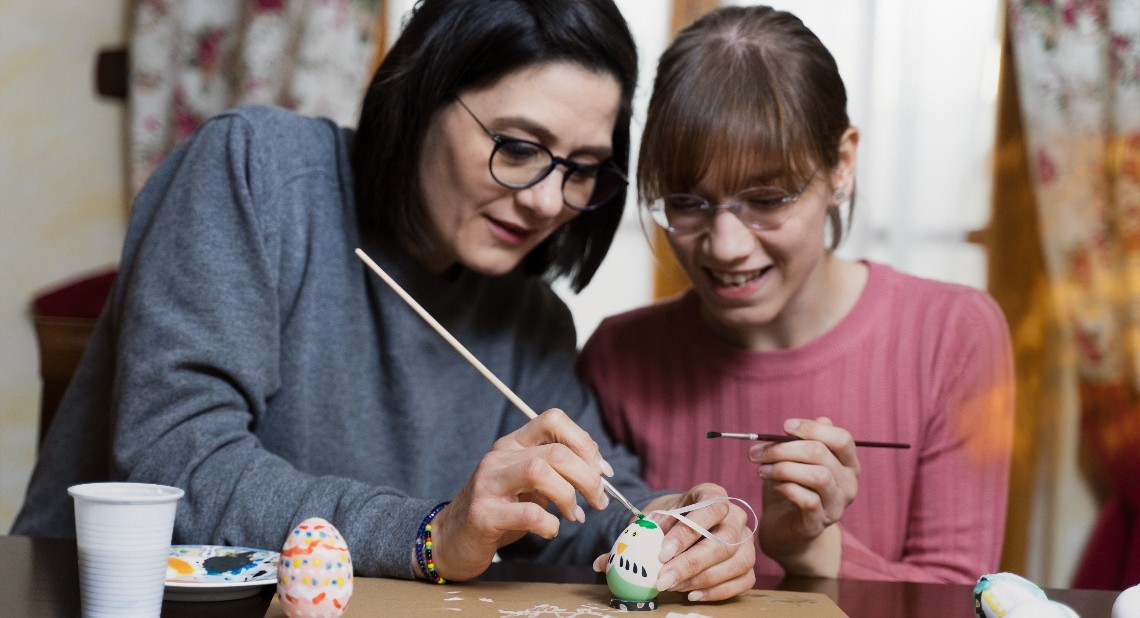 Women preparing and painting easter eggs together