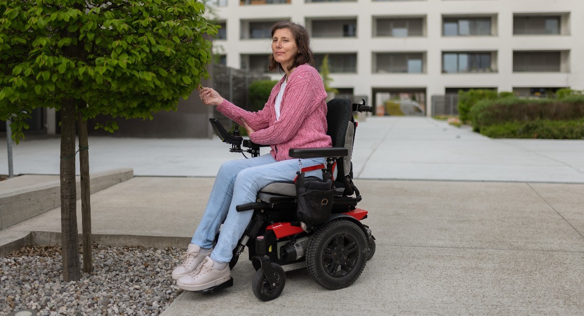 A disabled woman with a severe genetic defect in a powered wheelchair.