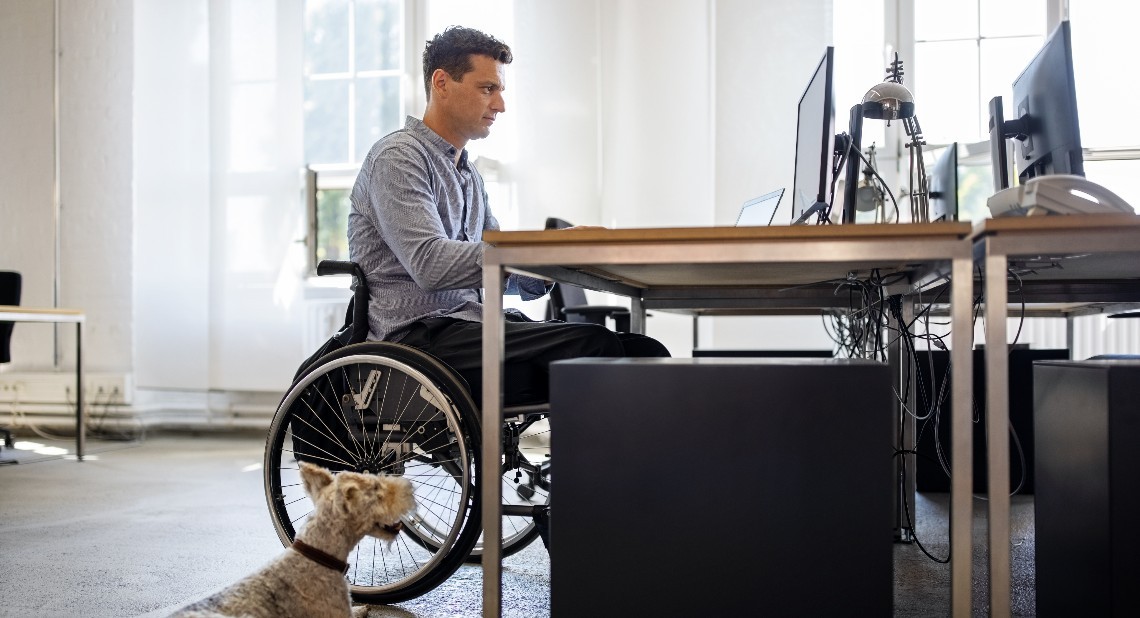 Man with disability on his laptop renewing his PIP application