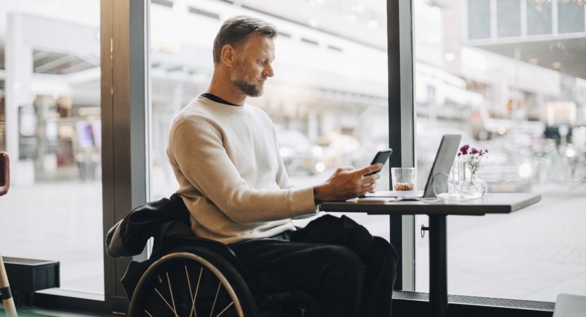 A man with disability on his phone checking PIP eligibility for mental health