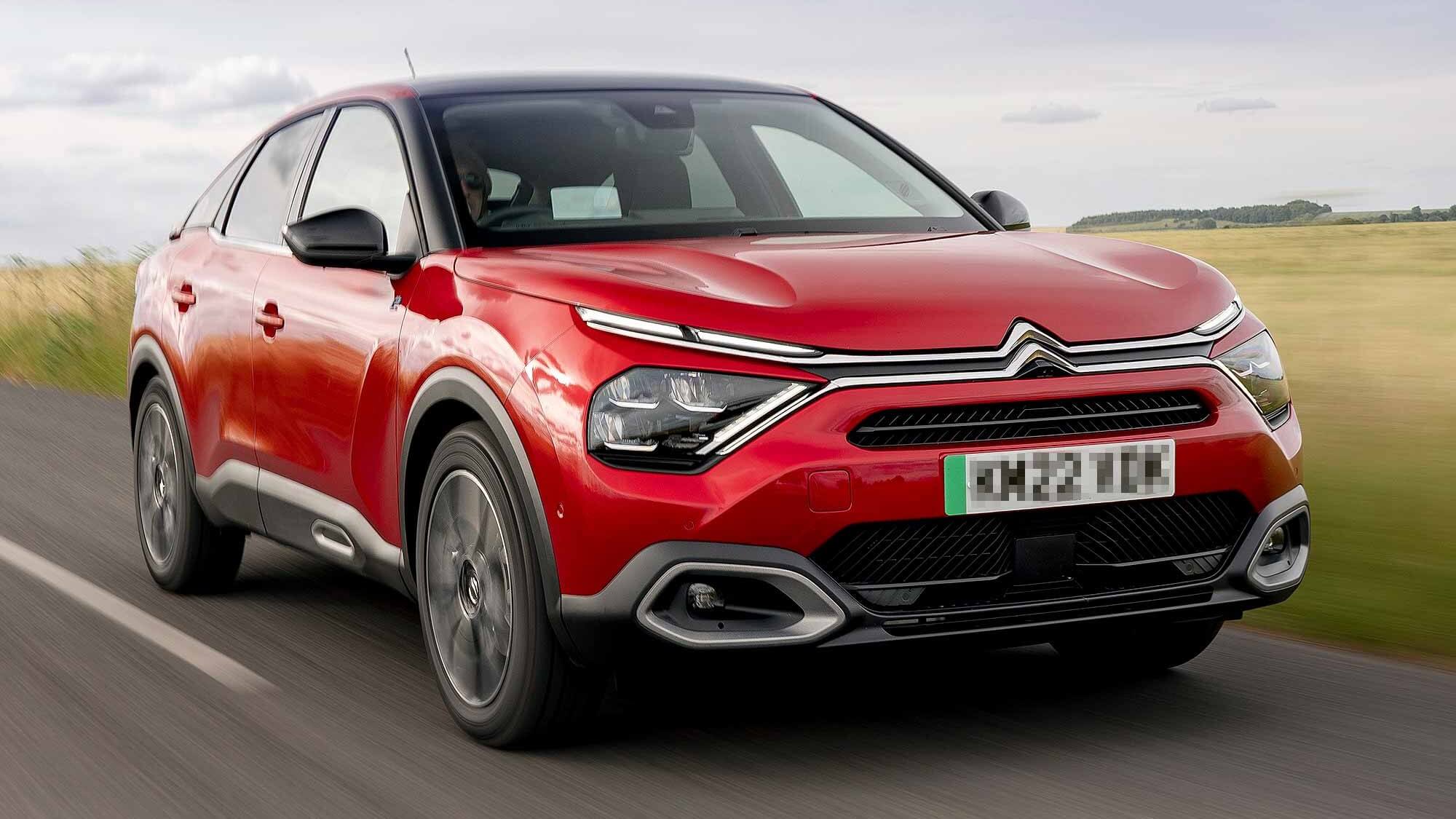 Red Citroen C4 driving on the road