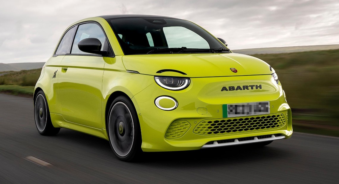 Bright yellow Abarth 500 driving on a road