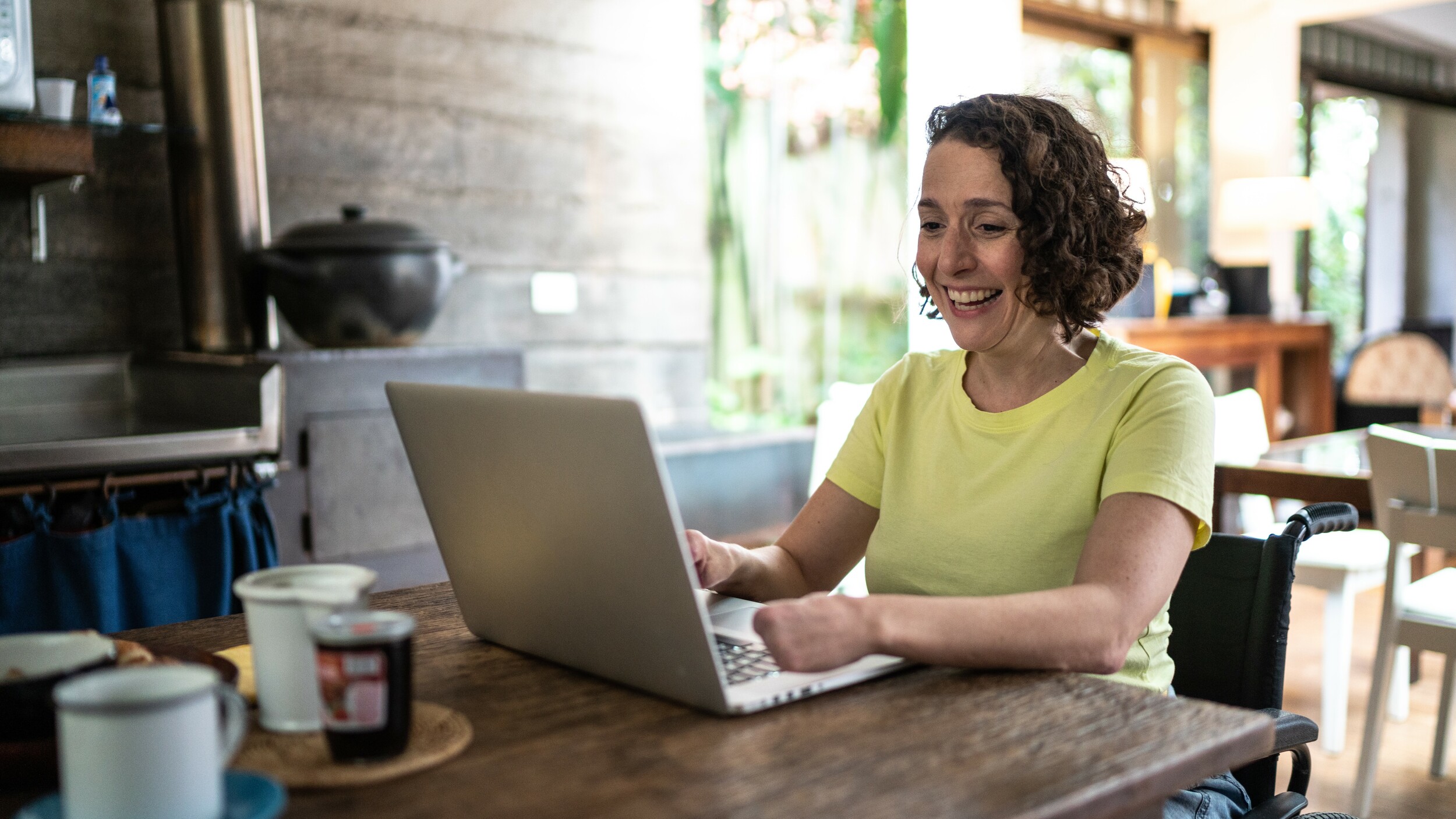 Woman sitting at her laptop smiling