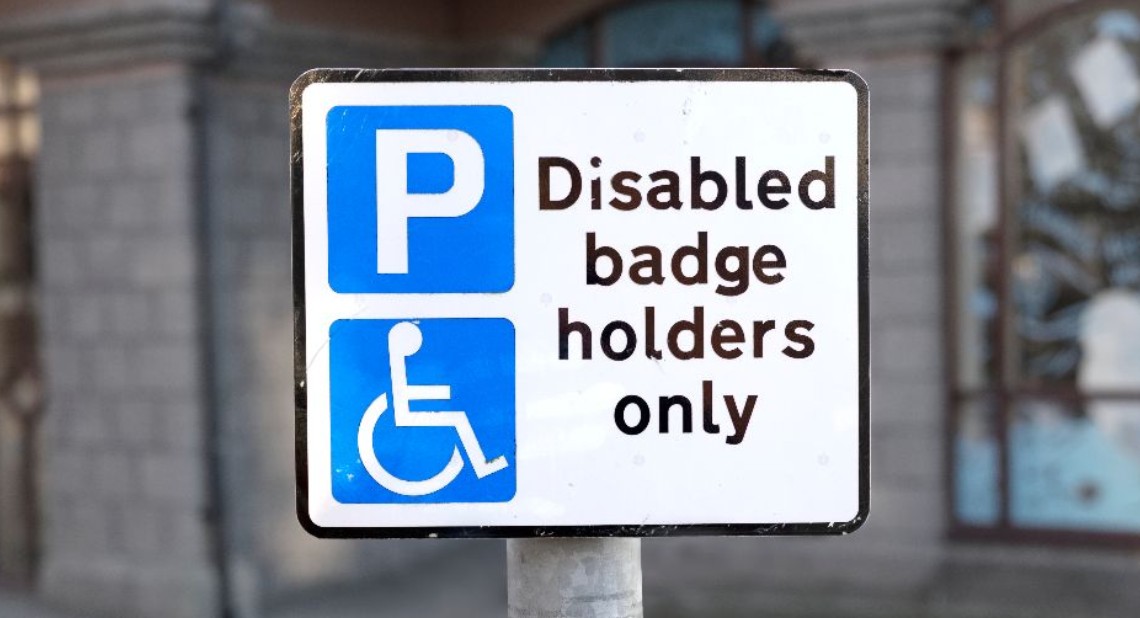 Disabled parking space sign post for badge holders only