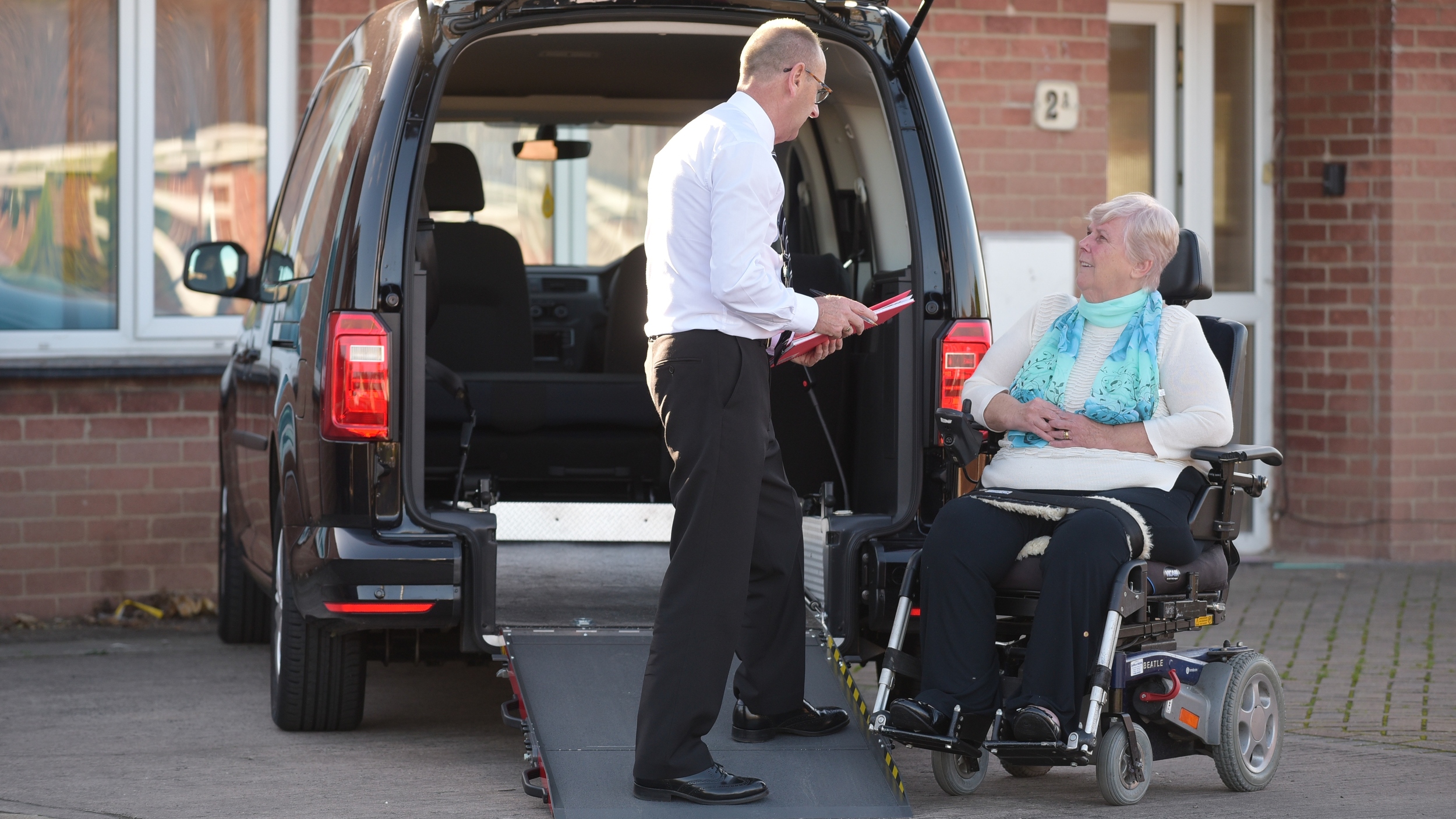 Woman talking to dealer about wheelchair accessible vehicle