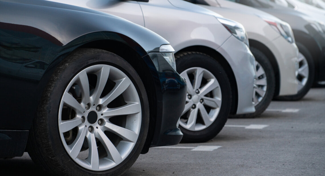 A lot of cars in a rows. Used car sales.